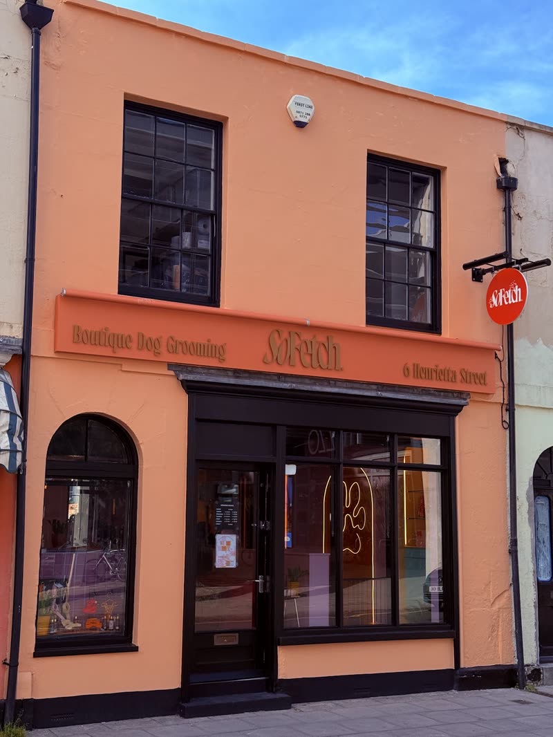 The peach-painted shopfront of the grooming studio on a terraced Cheltenham street